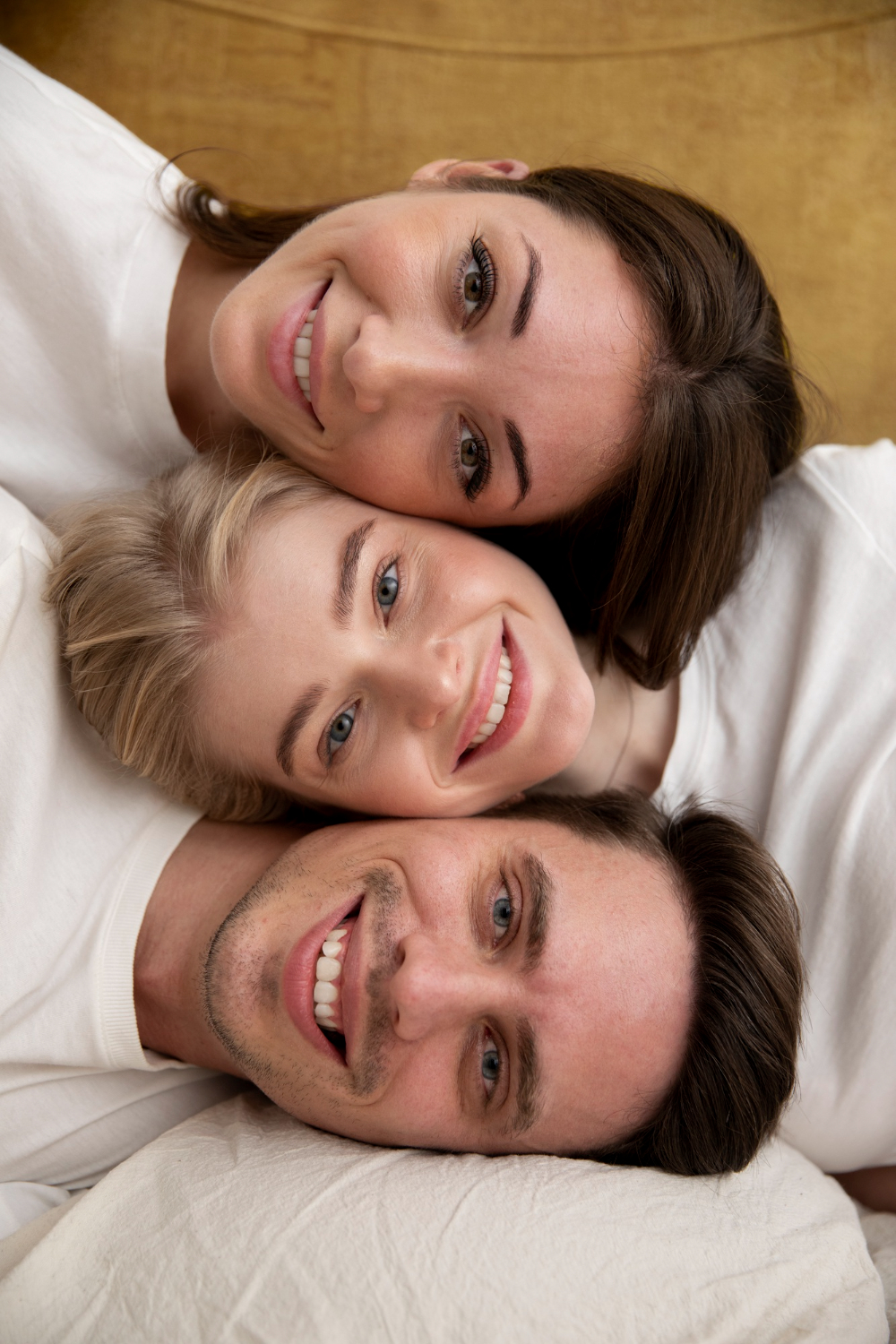 Three people showing off their happy smile.
