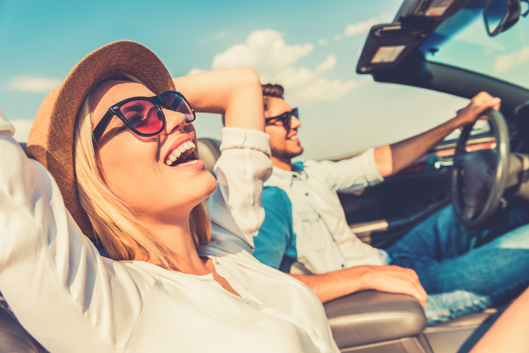 A happy couple driving on the open road.